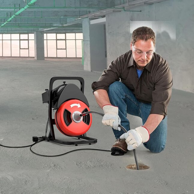 Plumber clearing a clogged drain in Astoria, NY