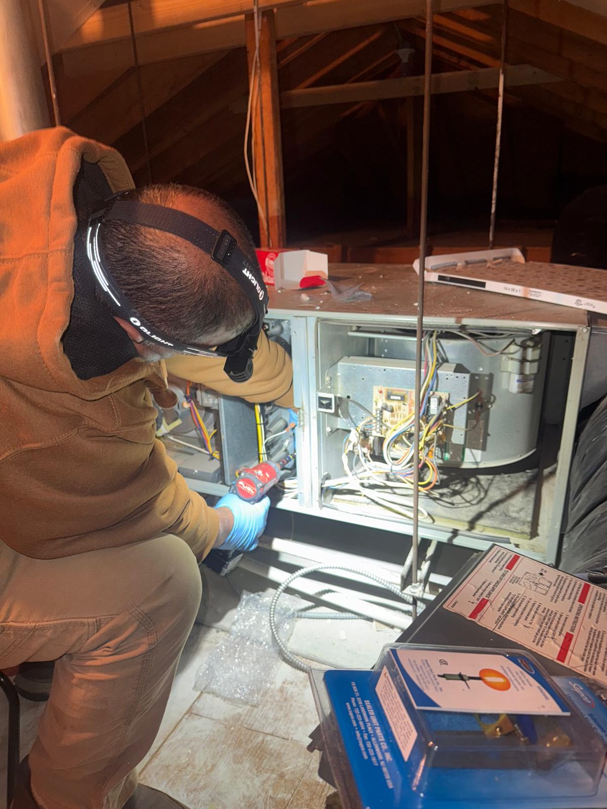 Technician repairing a furnace in Astoria, NY